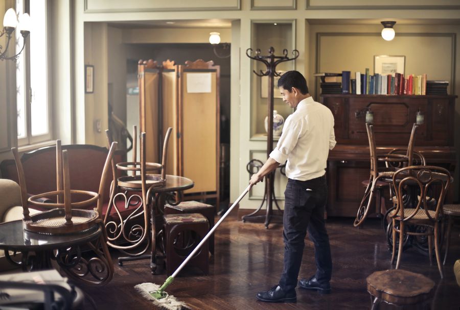 Professional mopping the floor of a commercial space